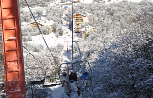 Skiers on lift at resort