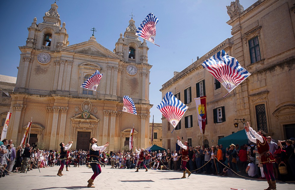 Men perform a flag dance at a medieval-style festival in Mdina, Malta