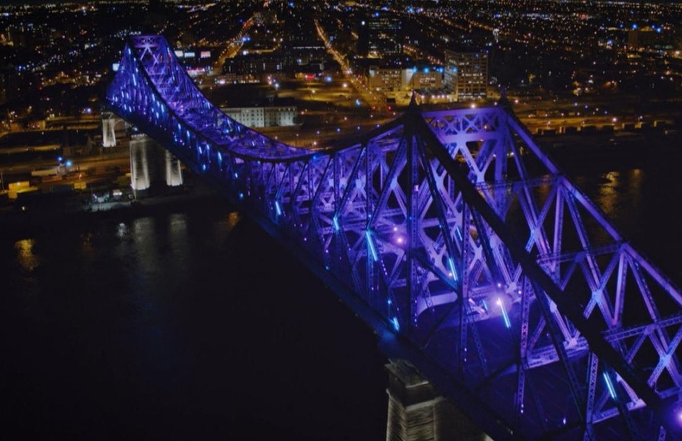 Montreal's Jacques Cartier bridge is turned purple during its hourly evening Living Connections light show.