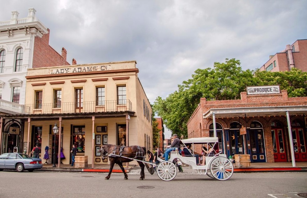 Visitors to Old Sacramento enjoy the view from a horse-drawn carriage 
