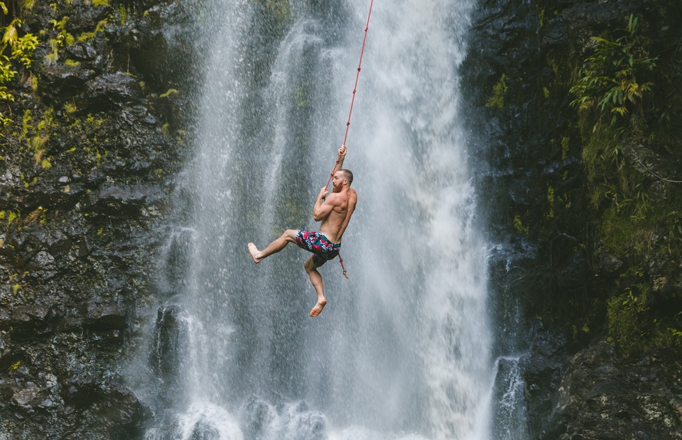 Waterfall rope swinging in Kauai, Hawaii