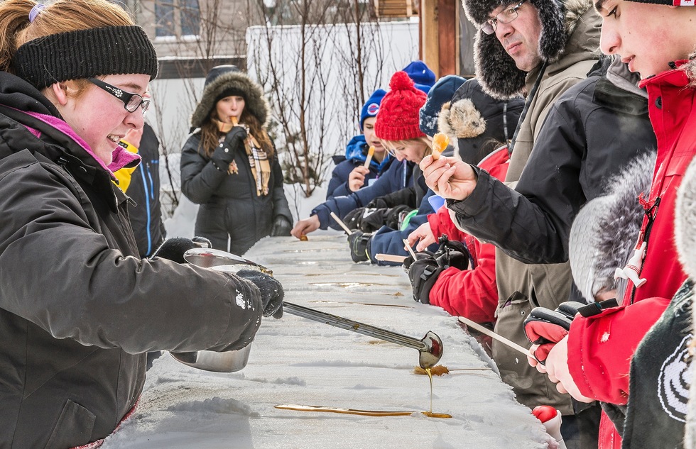 Making maple syrup candy on snow at Quebec City's annual winter carnival