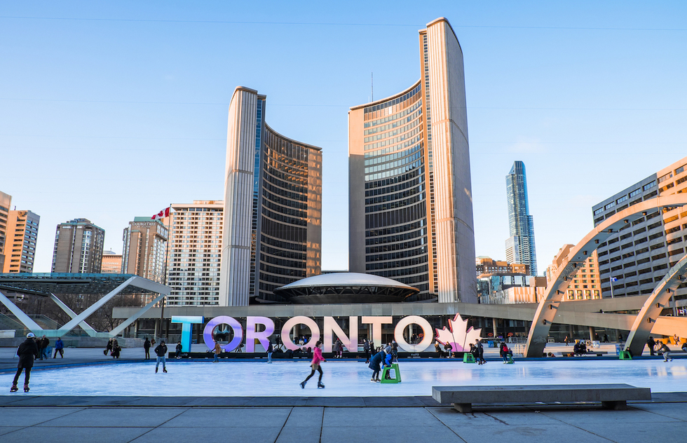 Toronto's futuristic city hall provides a backdrop to the fountain and skating rink at Nathan Phillips Square.