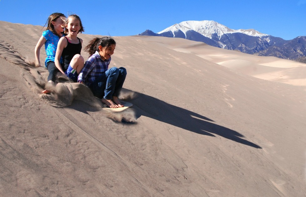 Sand sledding at Great Sand Dunes National Park in Colorado