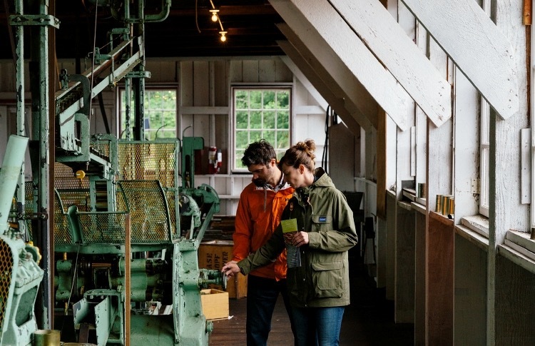 Visitors look at machinery inside the North Pacific Cannery National Historic Site in British Columbia.