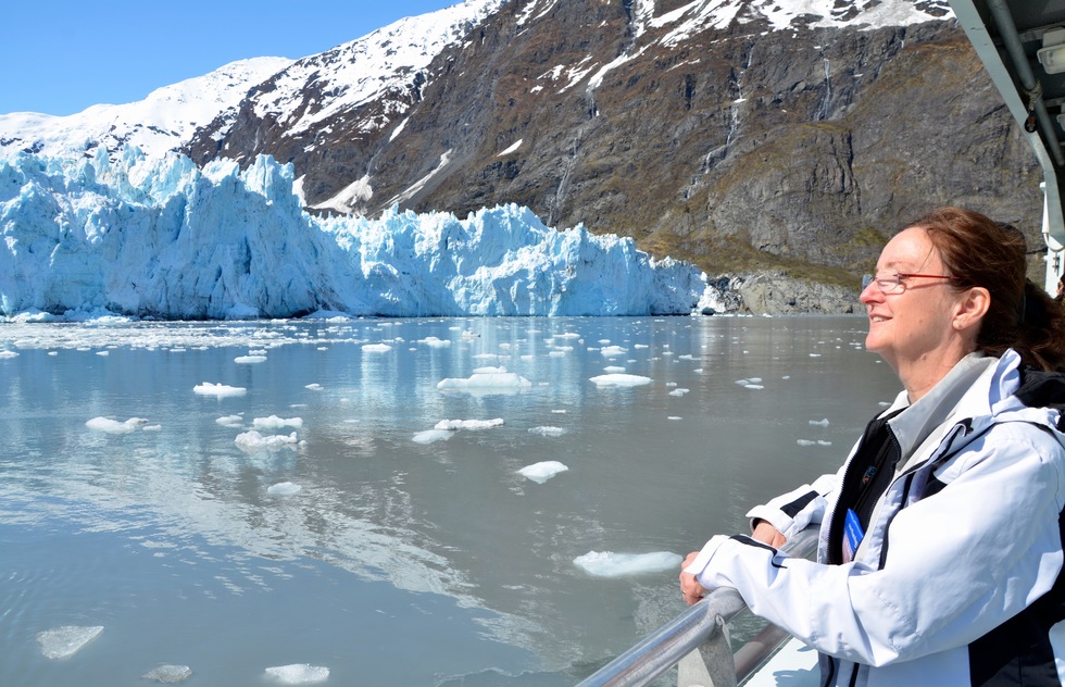 A woman on a glacier watching cruise.