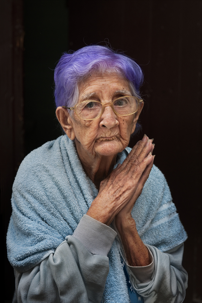 Photography from the book "In Search of Elsewhere: Unseen Images": Purple-haired woman in Havana, Cuba, in 2010