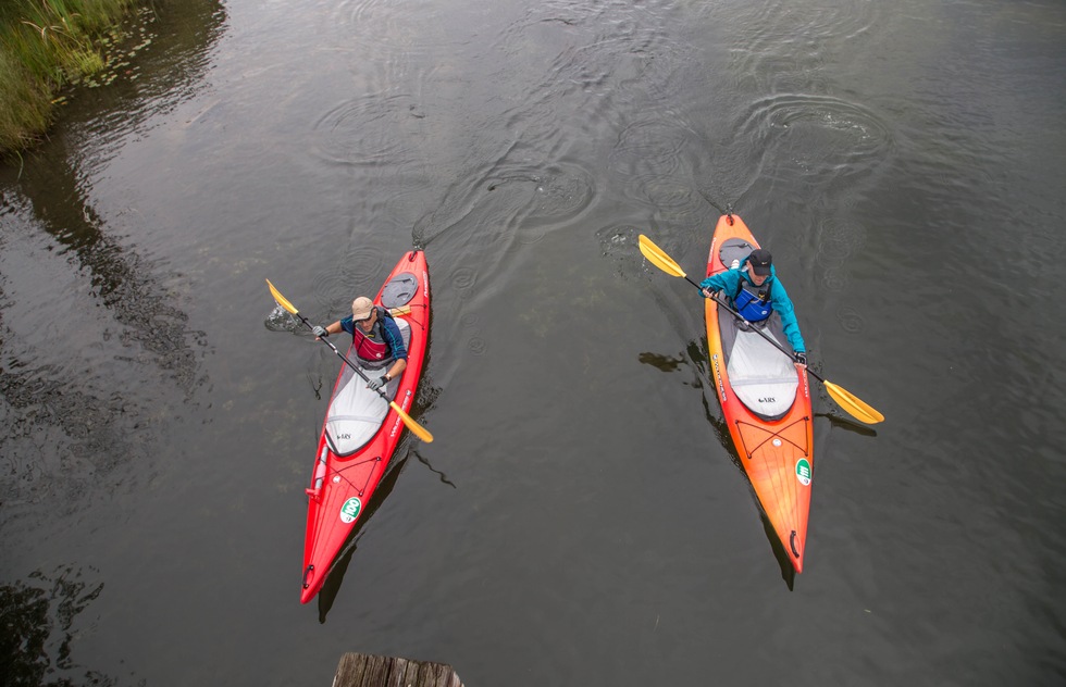 A group kayaks along the Intermediate River in Antrim County, Michigan