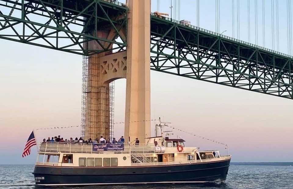 The Isle Royale Queen III sails under Mackinac Bridge