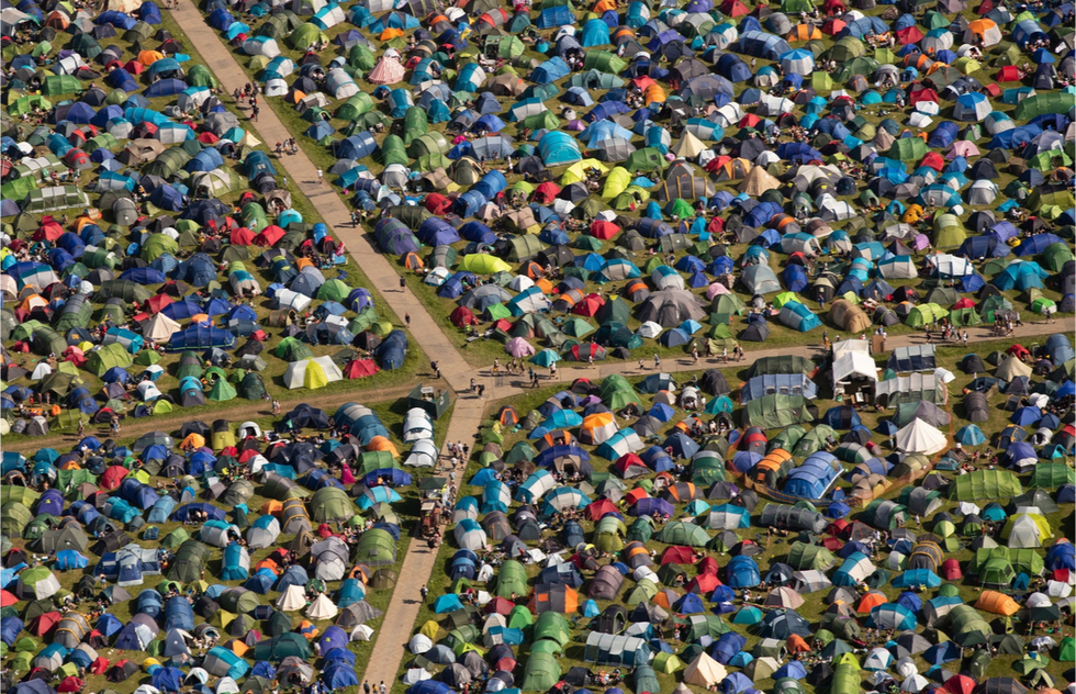 A meadow with dozens of tents at a music festival