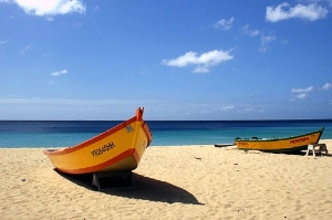 Boats, sand, and blue sky at Crashboat Beach, Puerto Rico.