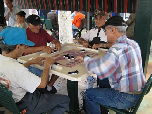 Men playing dominoes in Miami's Calle Ocho neighborhood. Miami, Florida.