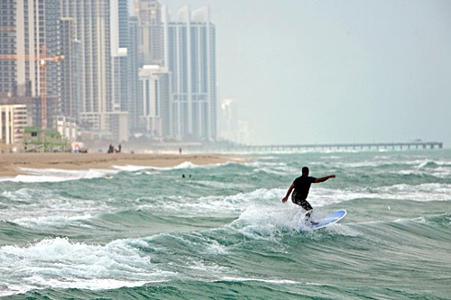 A surfer in the waves off Haulover Beach, Miami, Florida.