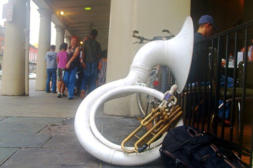 A sousaphone cadges for beignets outside Cafe du Monde in New Orleans.
