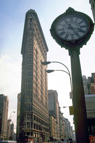 A large street clock near the Flatiron Building.