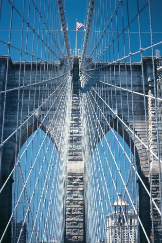 A view looking up at the spider's web of steel cables and wires on the Brooklyn Bridge.