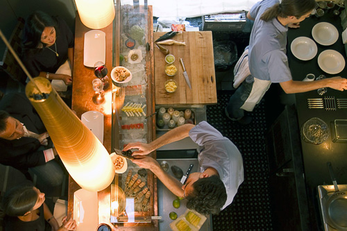 Kitchen staff and patrons at Minibar restaurant