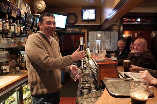 In Ireland, the pub is a way of life, not just a watering hole. Here the bartender at Mulligan's serves a pint of Guinness.