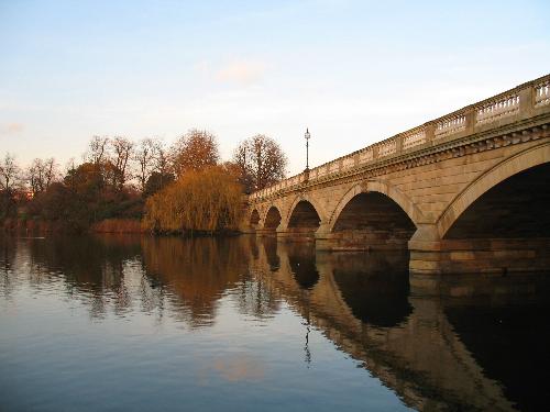 A bridge across the Serpentine River in Hyde Park during the late afternoon in late February.