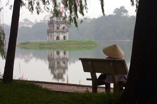 Woman relaxing on the banks of Hoan Kiem Lake, Hanoi
