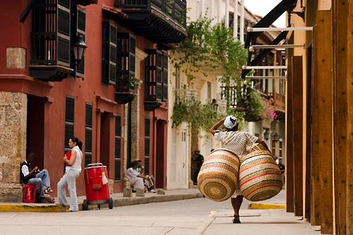 View of a basket seller walking the streets of Cartagena, an old colonial city in Colombia