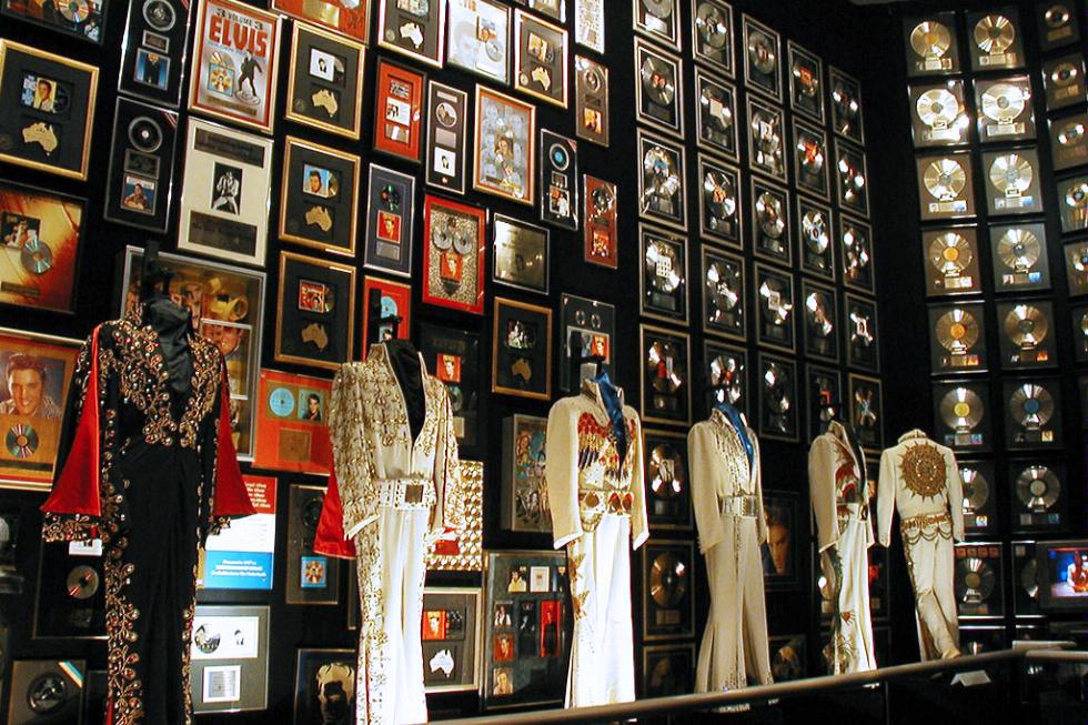 An exhibit of Elvis Presley's outfits and platinum records at Graceland in Memphis, Tennessee