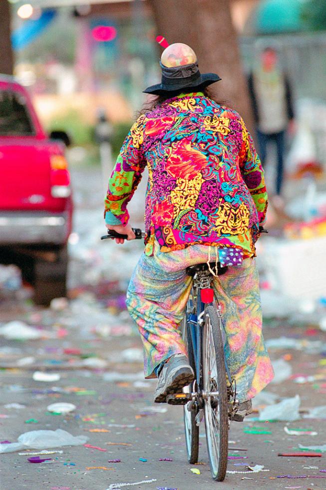 A biker pedals down a littered St. Charles Avenue just as Mardi Gras has ended in New Orleans, Louisiana.