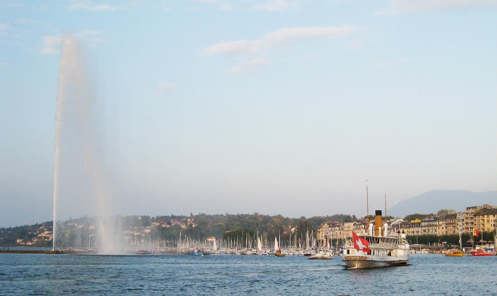 A boat passes by the Jet d'Eau, Lake Geneva, Geneva, Switzerland.