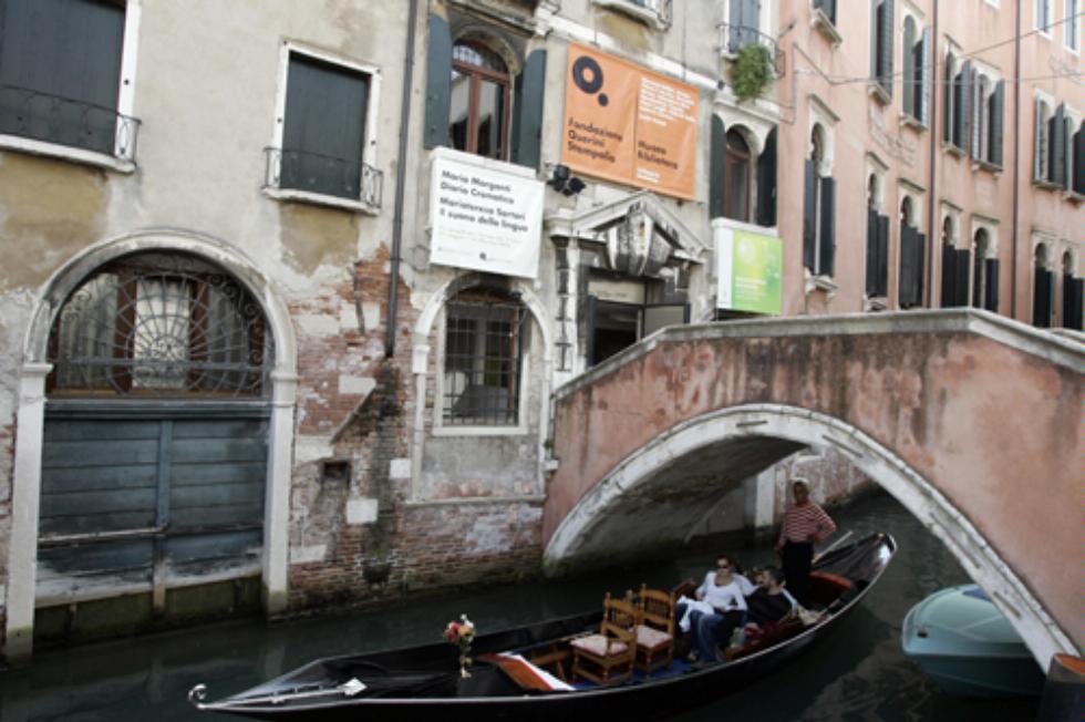 A gondola drifts by the Museo della Fondazione Querini Stampalia, Venice, Italy.