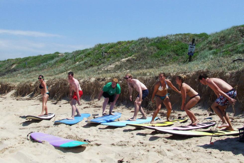 Students learn the proper way to stand on a board during a lesson at Waves Surf School in Sydney, Australia.