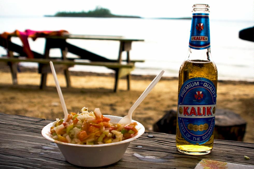 Fresh conch salad and cold Kalik beer at Governor's Harbour Friday Night Fish Fry, Bahamas.