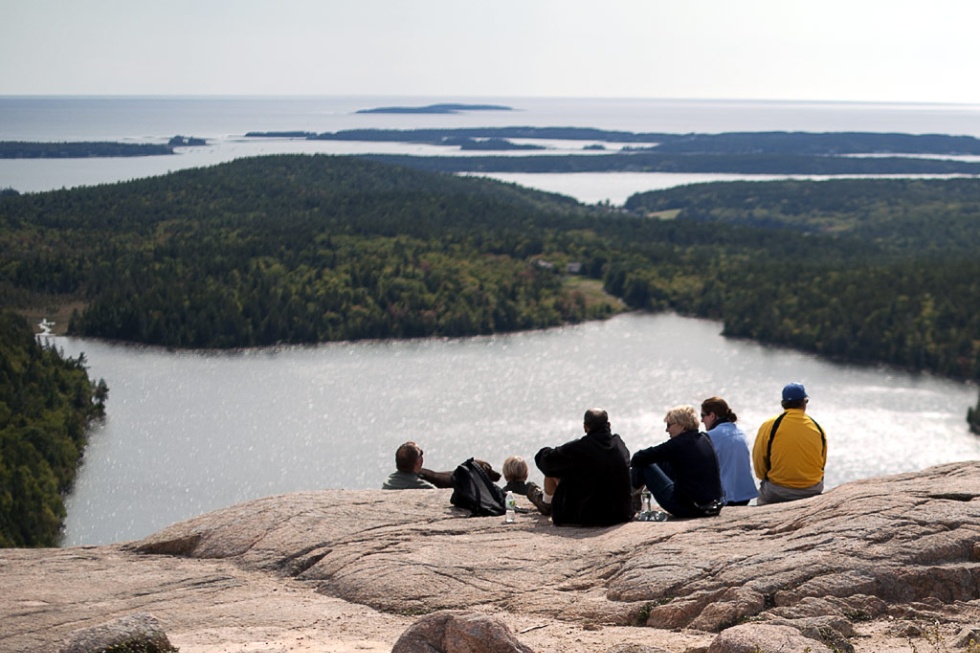 Hikers resting near the Bubbles in Acadia National Park, ME.