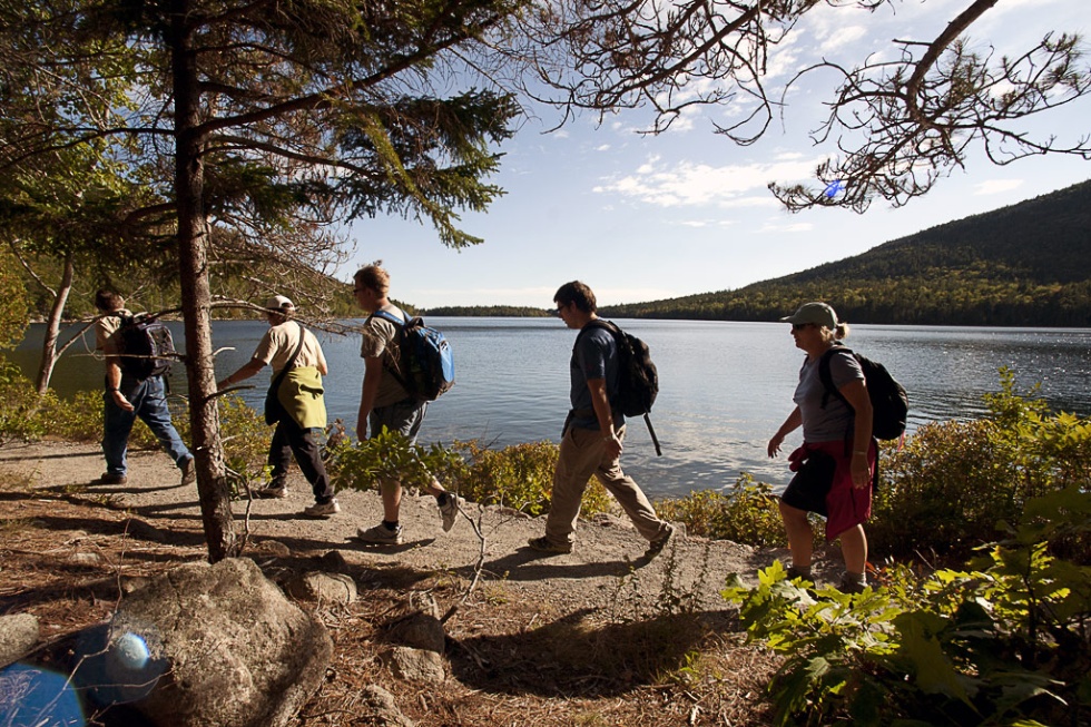 Hikers along the shores of Jordan Pond in Acadia National Park, ME.