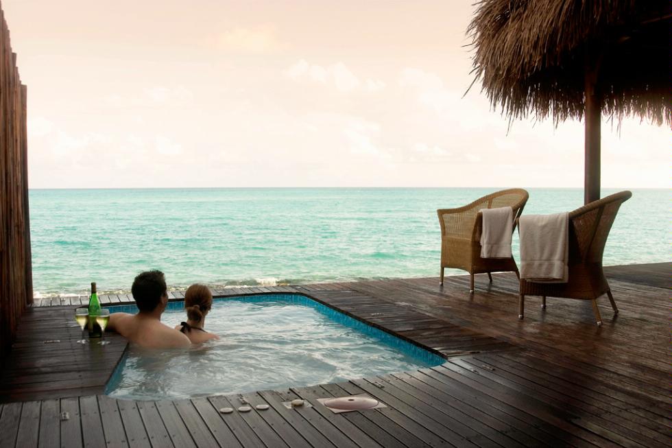 Couple enjoying the Plunge Pool at Medjumbe Resort, located on a private island off the coast of Mozambique.