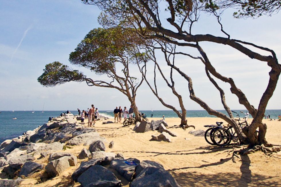 Beachgoers and cyclists at Balboa Beach in Orange County, California.