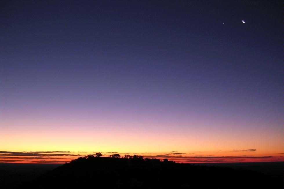 Sunset is over the summit of Siding Spring mountain in the  Warrumbungle National Park in New South Wales, Australia.
