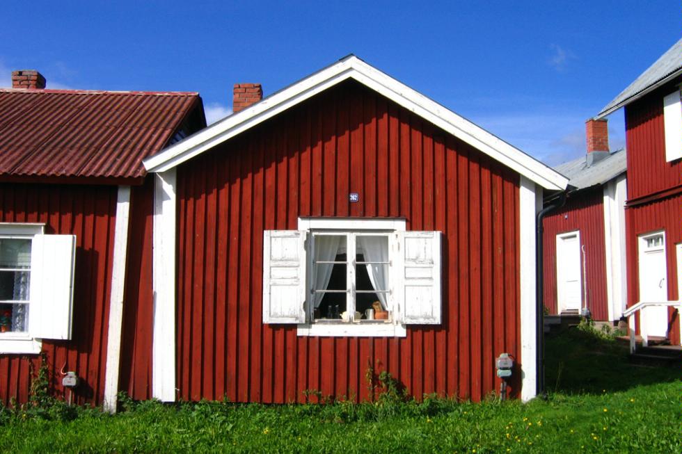 Red wooden houses dot the landscape in Gammelstad, Lulea.