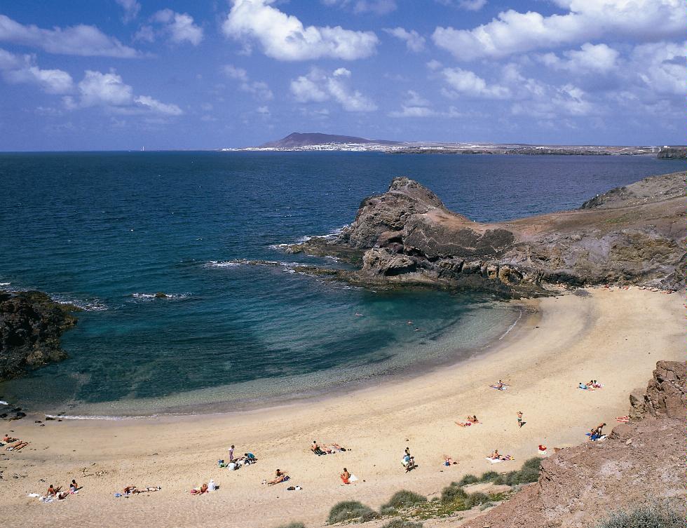 Sunbathers on Punta del Papagayo, Lanzarote, Canary Islands.