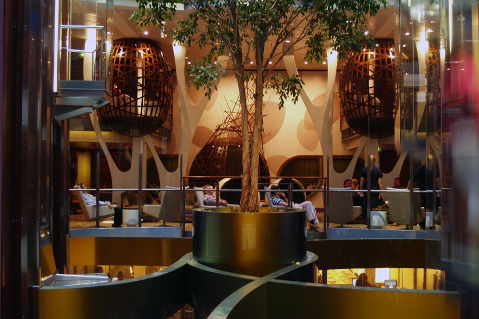 A view across Celebrity Silhouette's atrium, where a living tree is suspended six decks above the lobby. Across the gap is The Hideaway, Silhouette's "tree house."