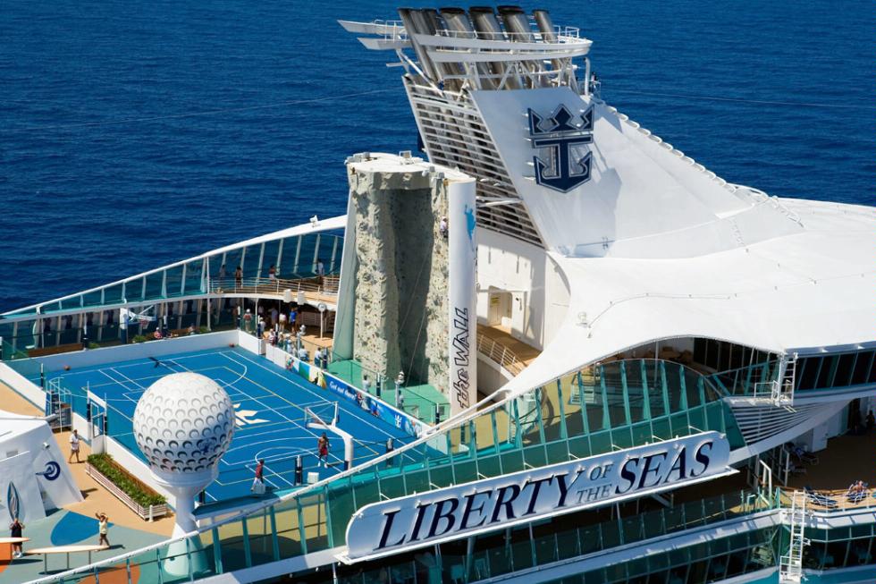 The sports deck of Royal Caribbean's Liberty of the Seas, featuring a basketball court and a rock wall.