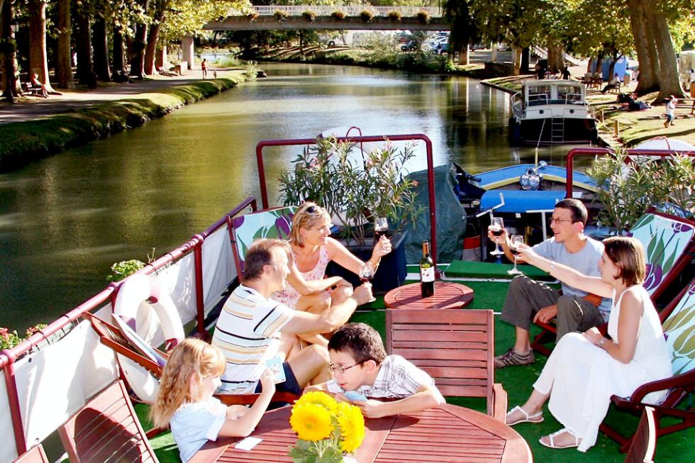 A family enjoys a trip through France aboard the European Waterways barge Rosa.